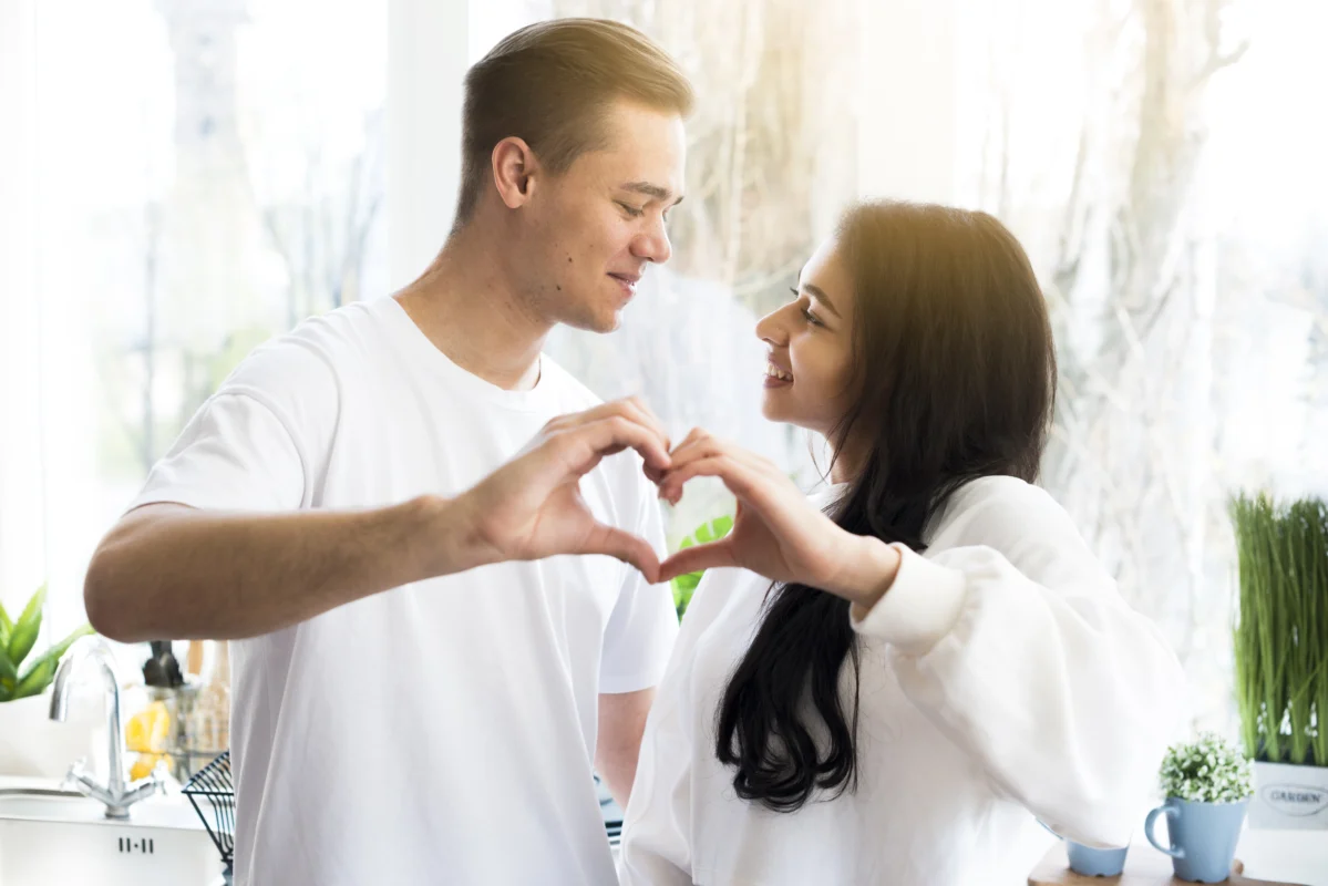 multiracial couple making love gesture looking each other